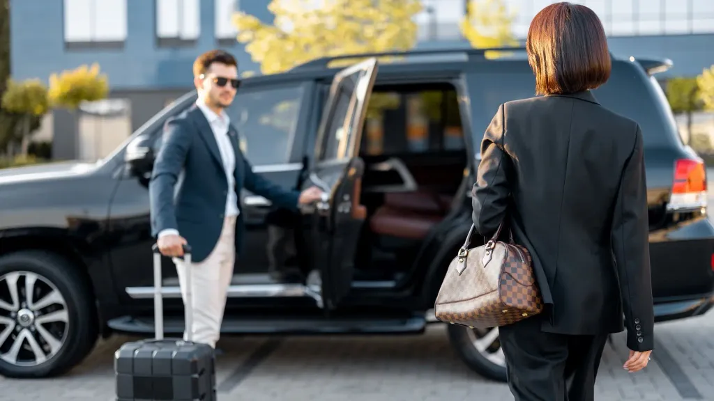 Comfort Drive chauffeur loading a client's luggage into a car for a Dubai airport transfer