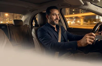 Designated driver in Dubai driving a client home safely in their own car at night